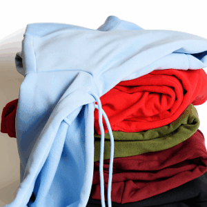 Stack of folded hoodies in various colors.