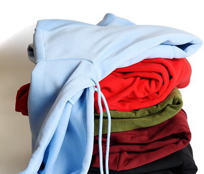 Stack of folded hoodies in various colors.